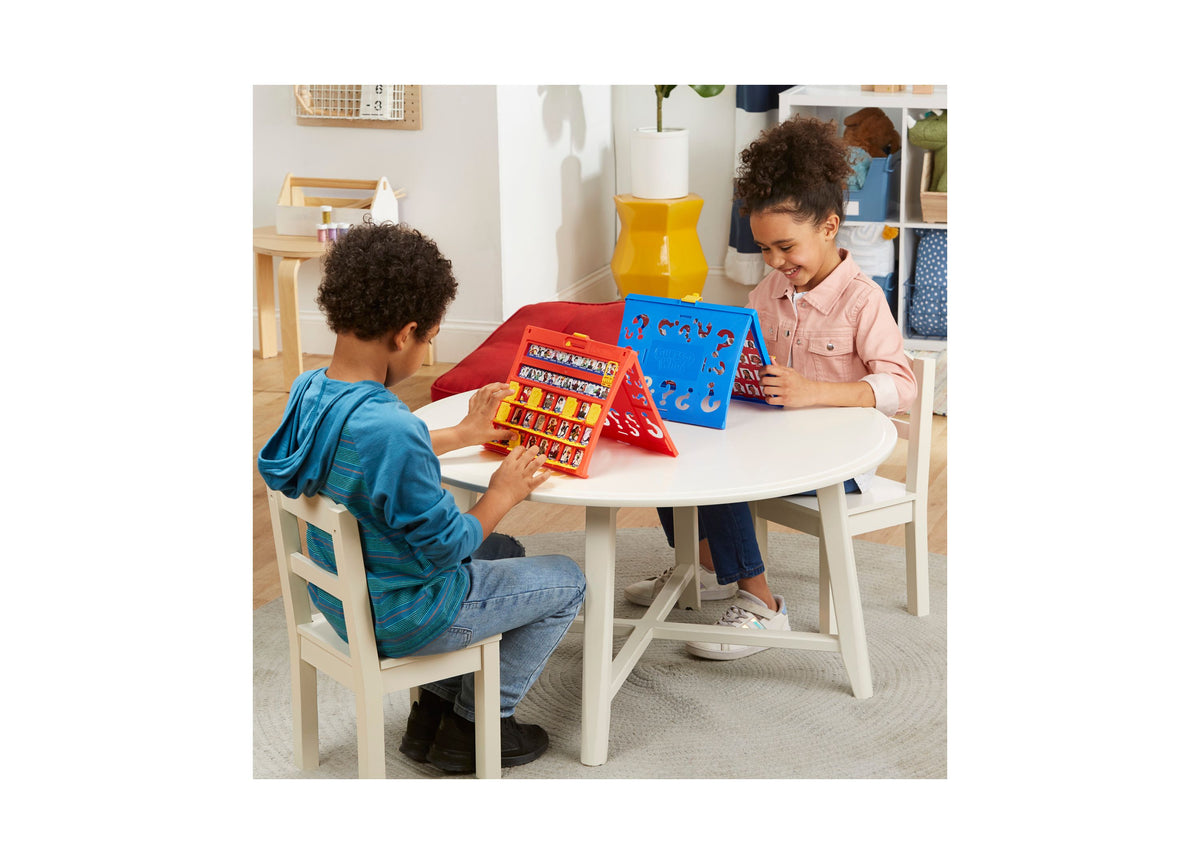 Hasbro Guess Who Classic Character Guessing Game with two players at round table, red and blue game frames visible