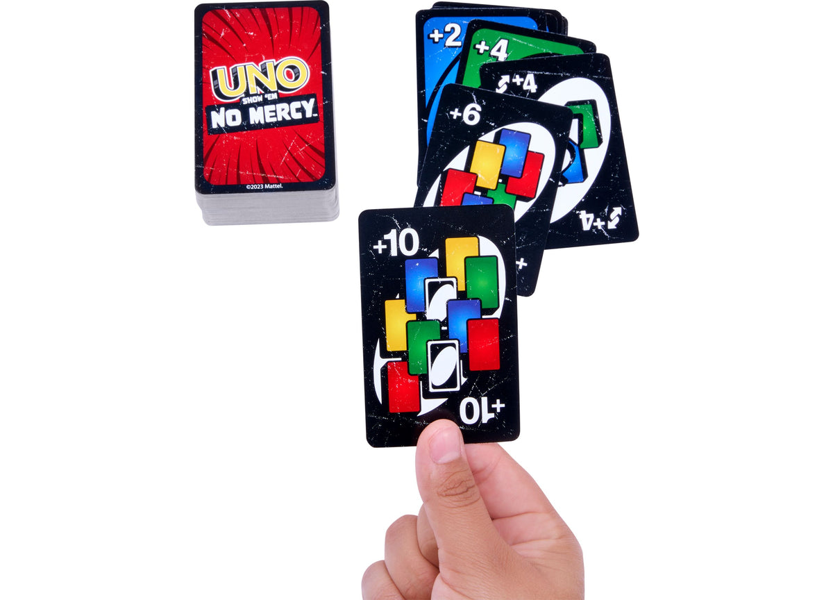 UNO Show 'Em No Mercy card game with deck box and spread of black challenge cards showing point values +2, +4, +6, +1...