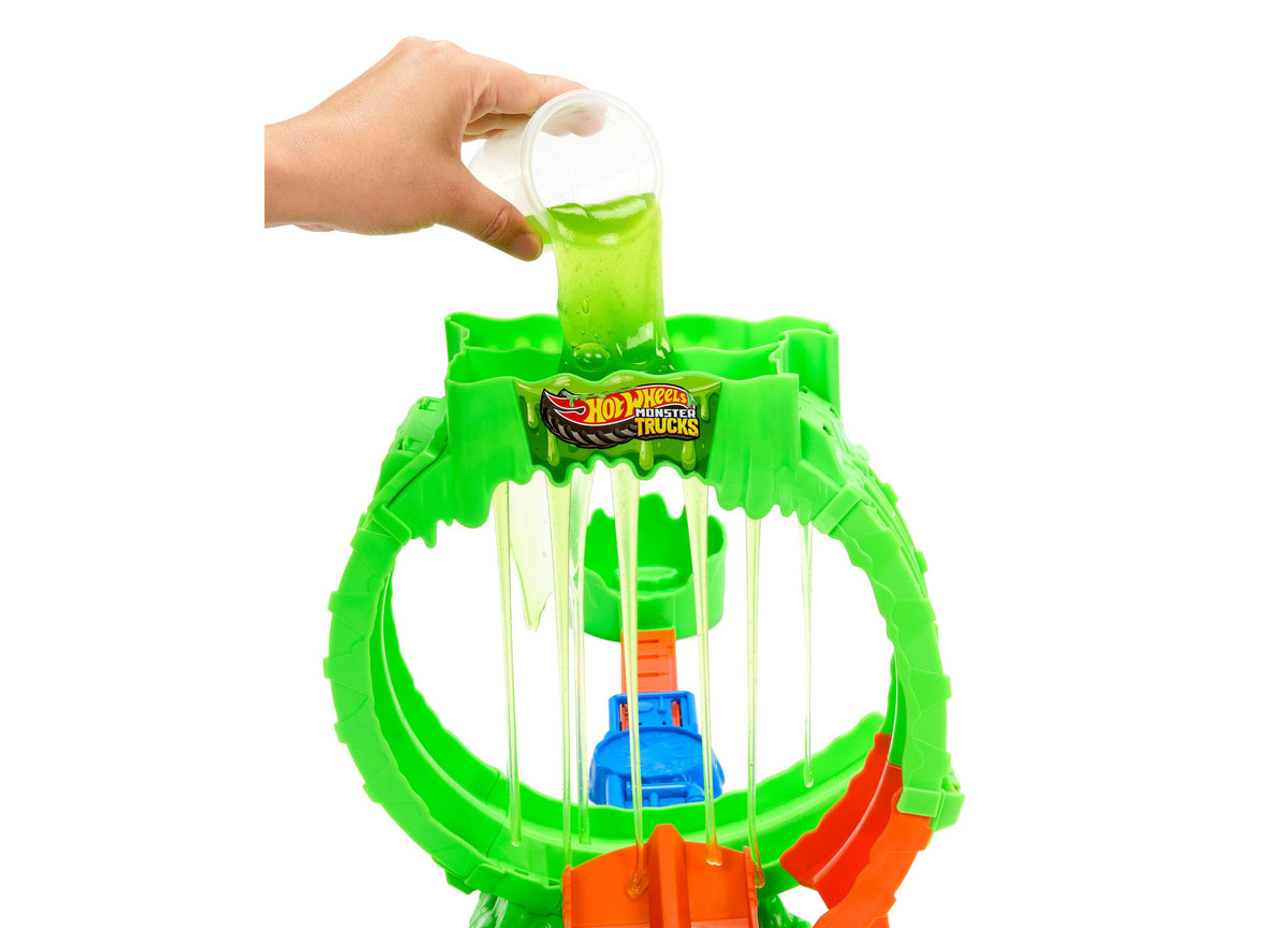 Hot Wheels Monster Trucks Mutant Chaos Loop playset with green slime being poured from cup