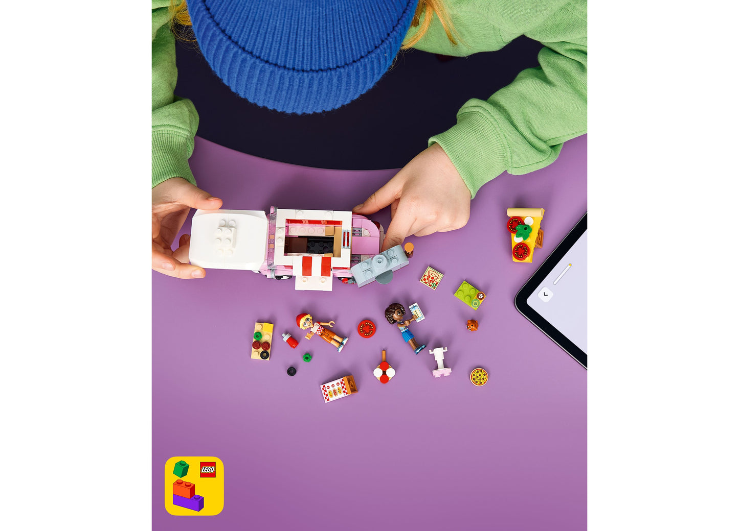 LEGO Friends Pizza Truck 42694 building set with colorful pieces displayed on purple surface