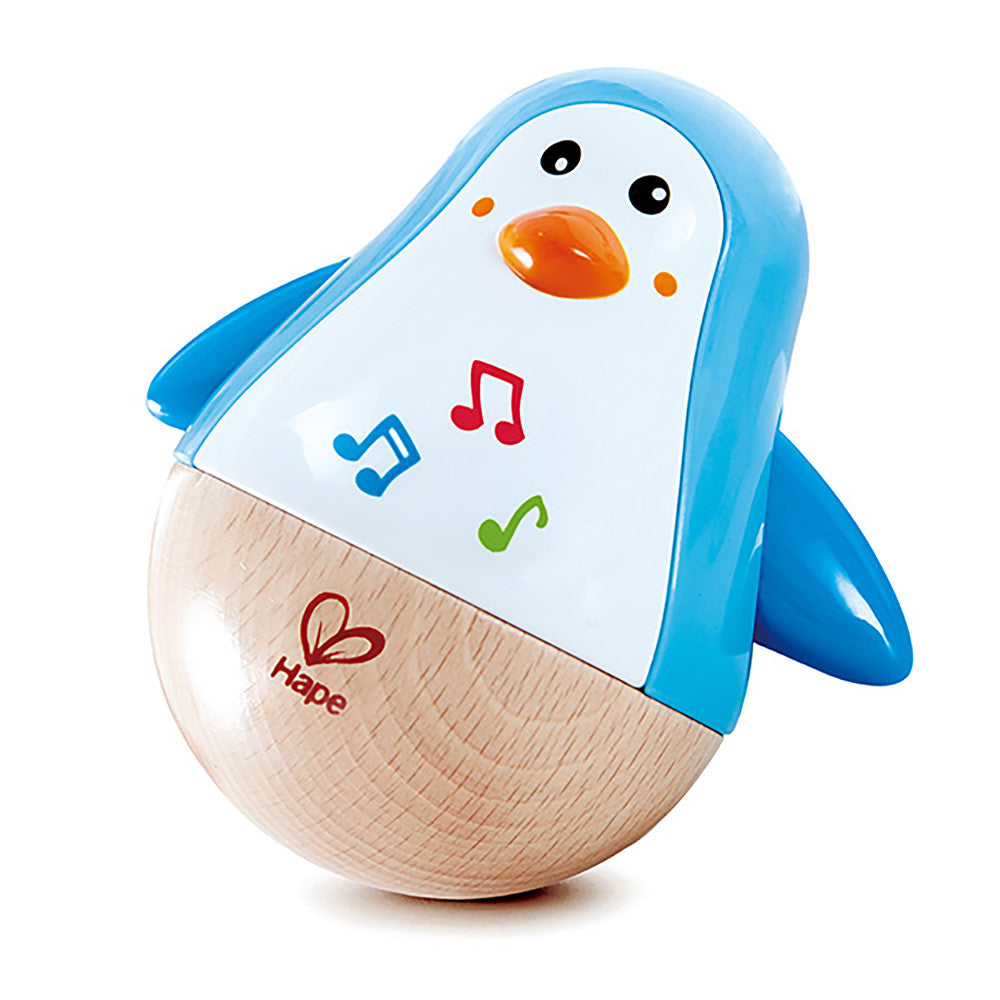 Blue and natural wood penguin-shaped wobbler toy with orange beak, black eyes, and colorful musical note graphics on white chest panel