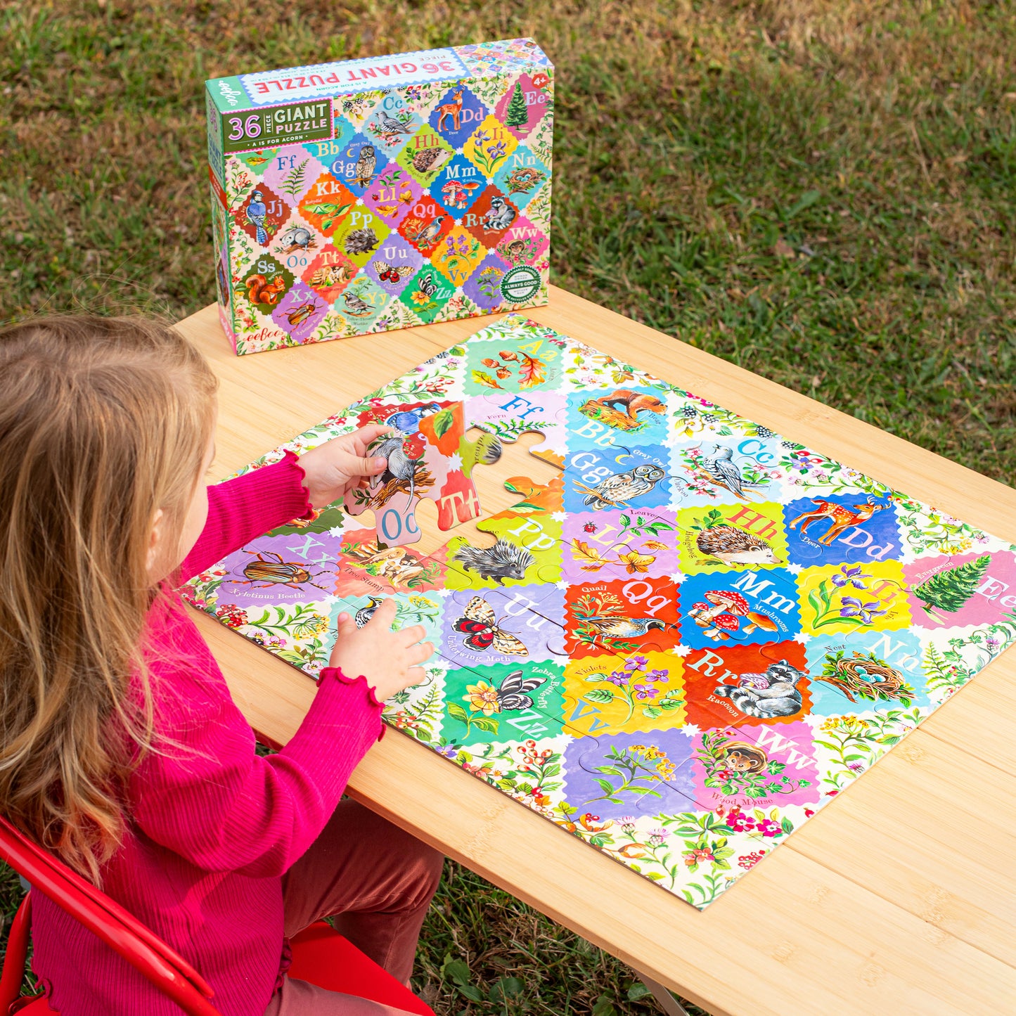 36 Piece Giant Alphabet Puzzle with colorful letters and nature illustrations, child playing outdoors
