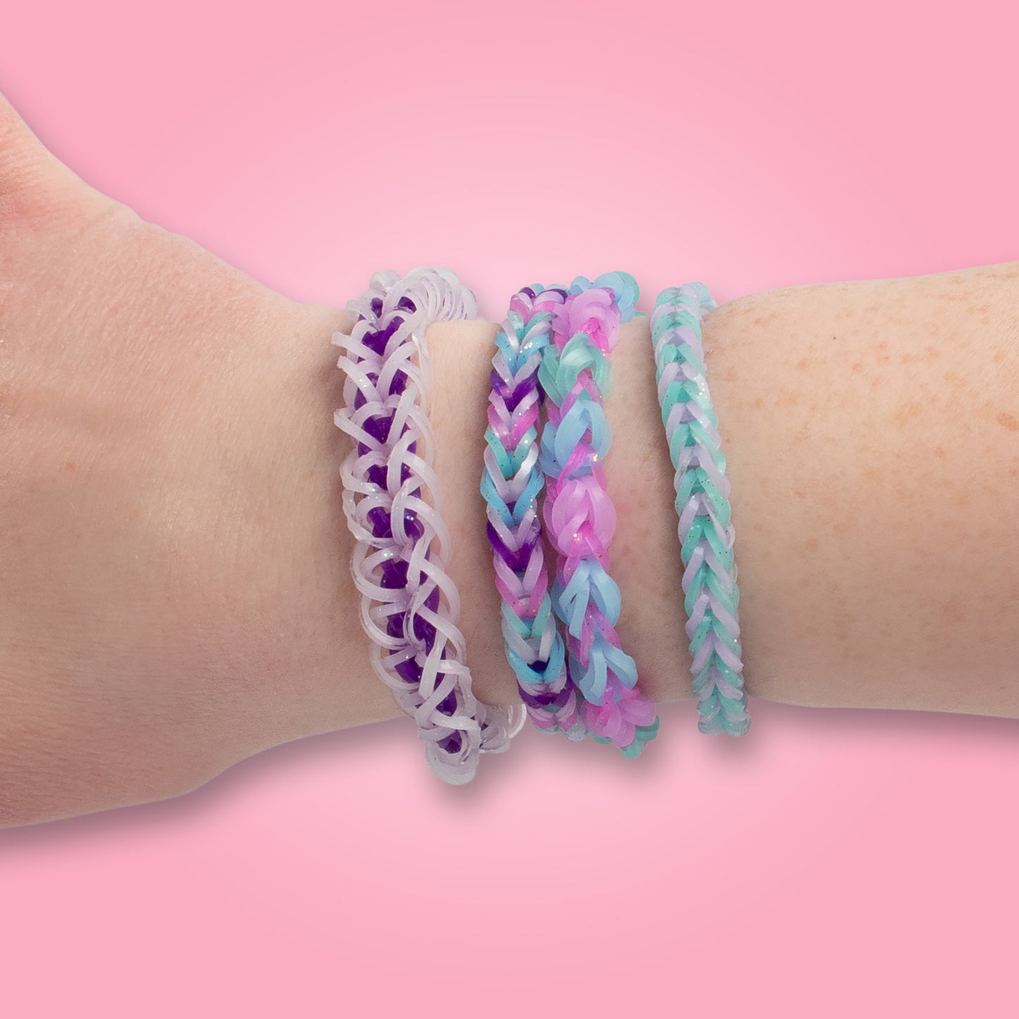 Rainbow Loom Sparkle Pop bracelets in purple, pink, and turquoise chevron patterns