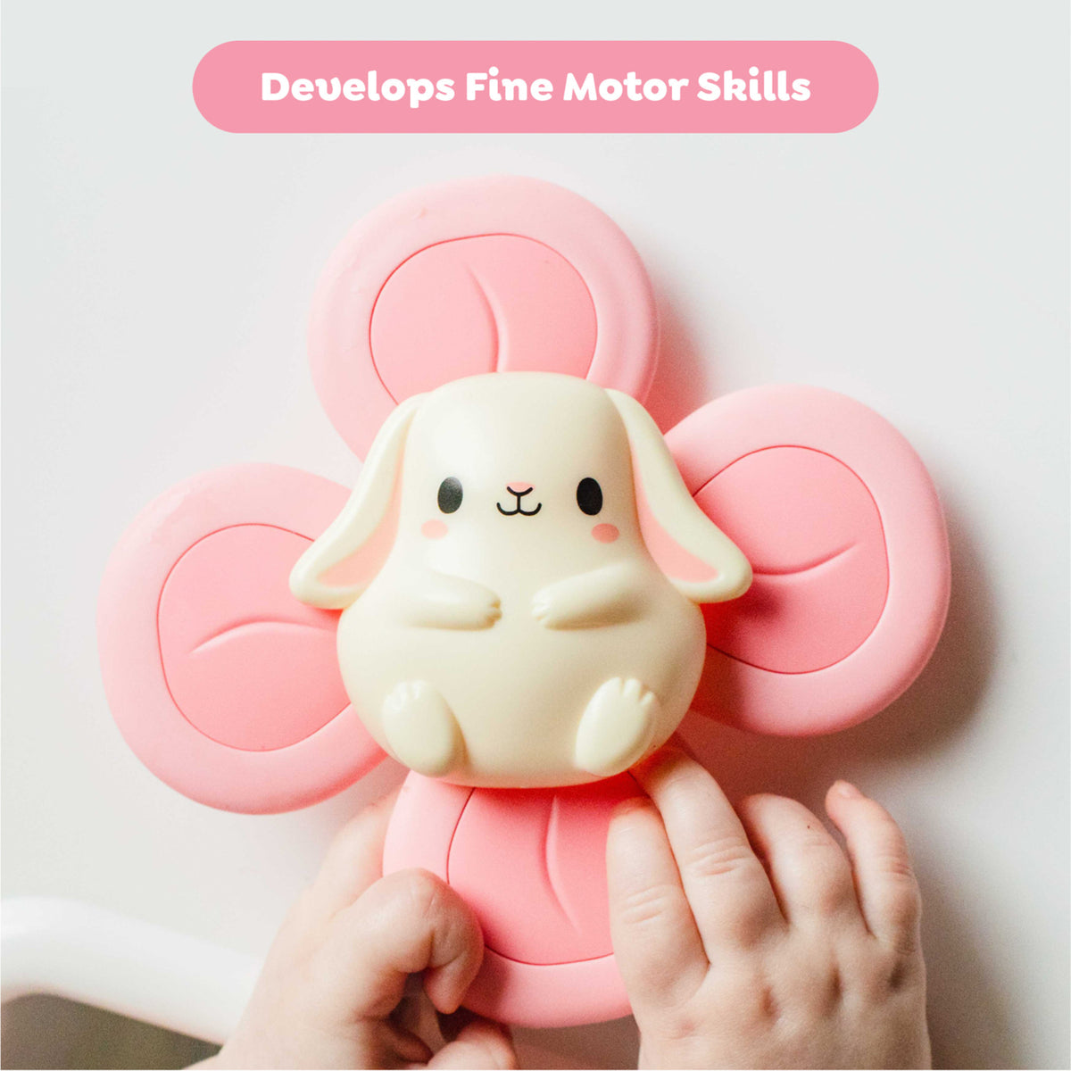 Sensory Spinner: Bunny toy with cream bunny character and pink four-paddle spinner, held in child's hands