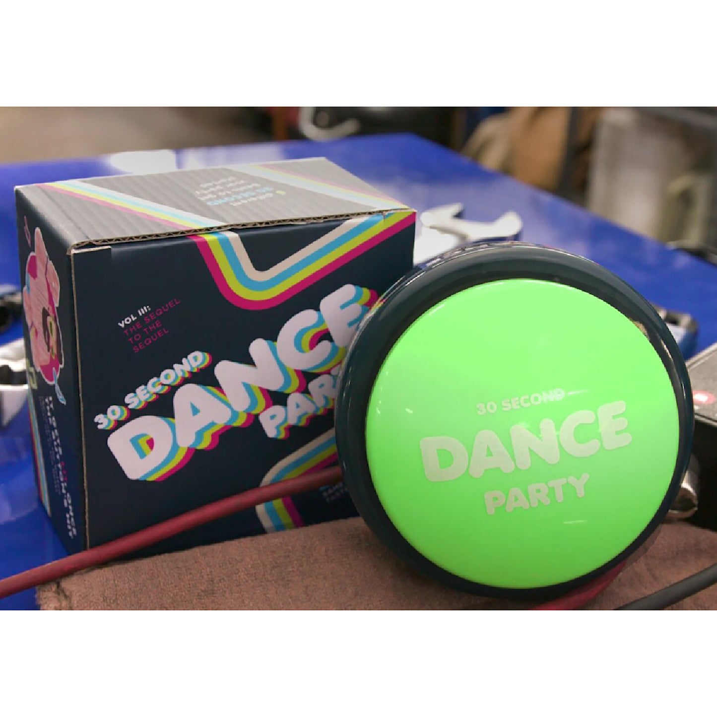 30 Second Dance Party green button toy with colorful rainbow packaging box