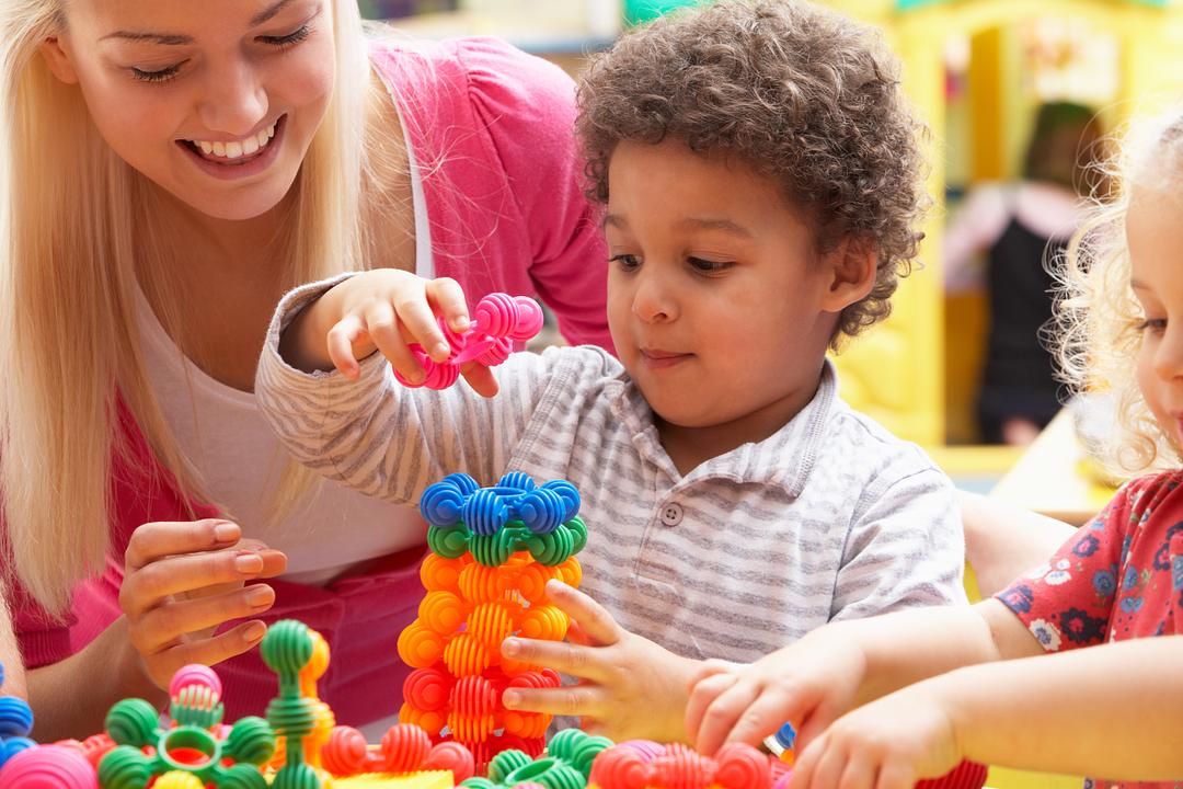 Mom and child playing with toy stacking set