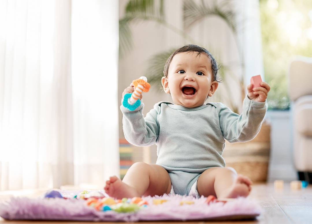 Infant playing with teether toy