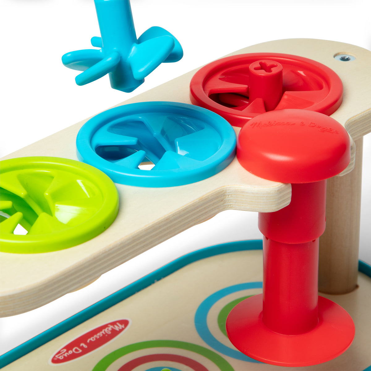 Melissa & Doug Match & Push Spinning Tops wooden toy with colorful blue, red, and green tops