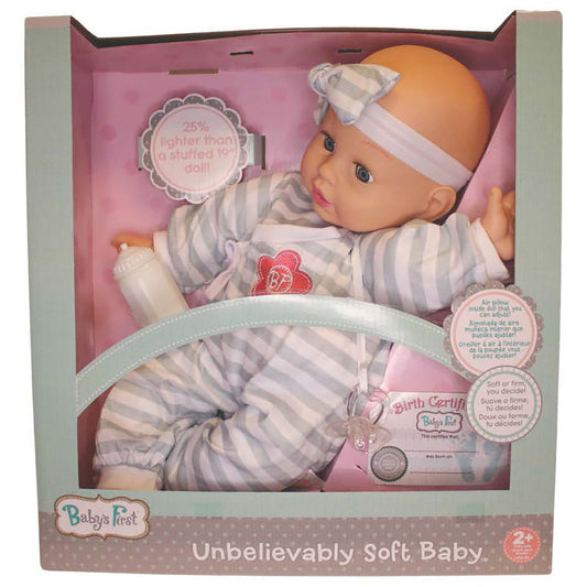 Baby's First soft body doll with peach-toned face, striped gray and white outfit, pink headband, and matching striped pants in packaging