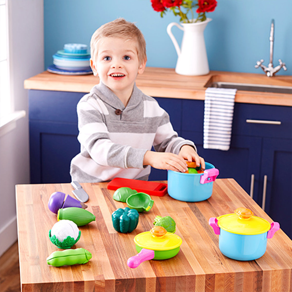 Young Chef's Cookware 11-Piece Playset with colorful pots, pans, and play vegetables