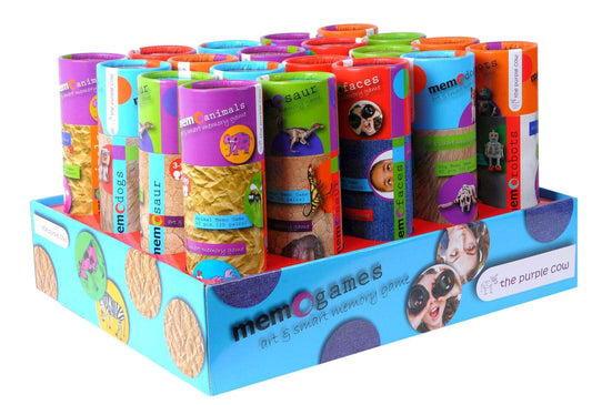 Memo Games display with multiple colorful cylindrical boxes featuring animals, dinosaurs, faces, and robots themes in a blue retail tray