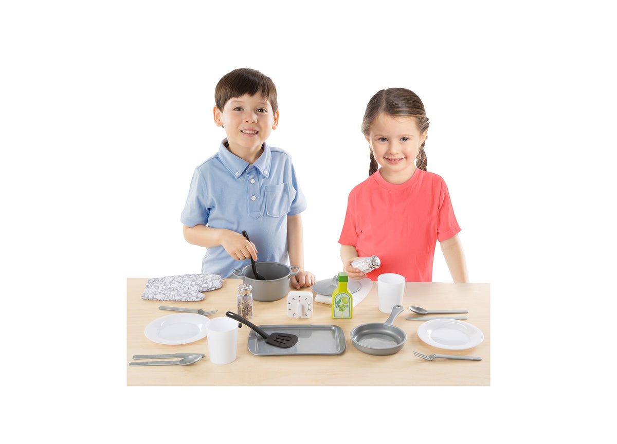 Melissa & Doug 22-Piece Play Kitchen Accessories Set with two children at table