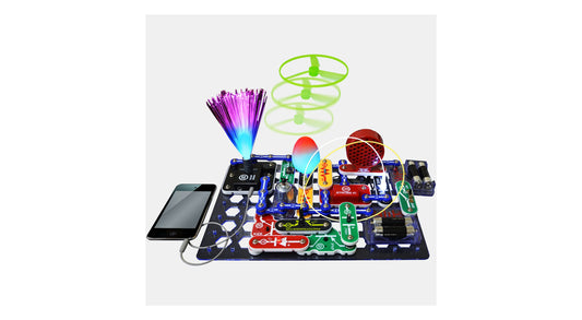 Snap Circuits LIGHT kit with electronic components on blue base board connected to smartphone, featuring illuminated fiber optic strands, green spiral tower, an