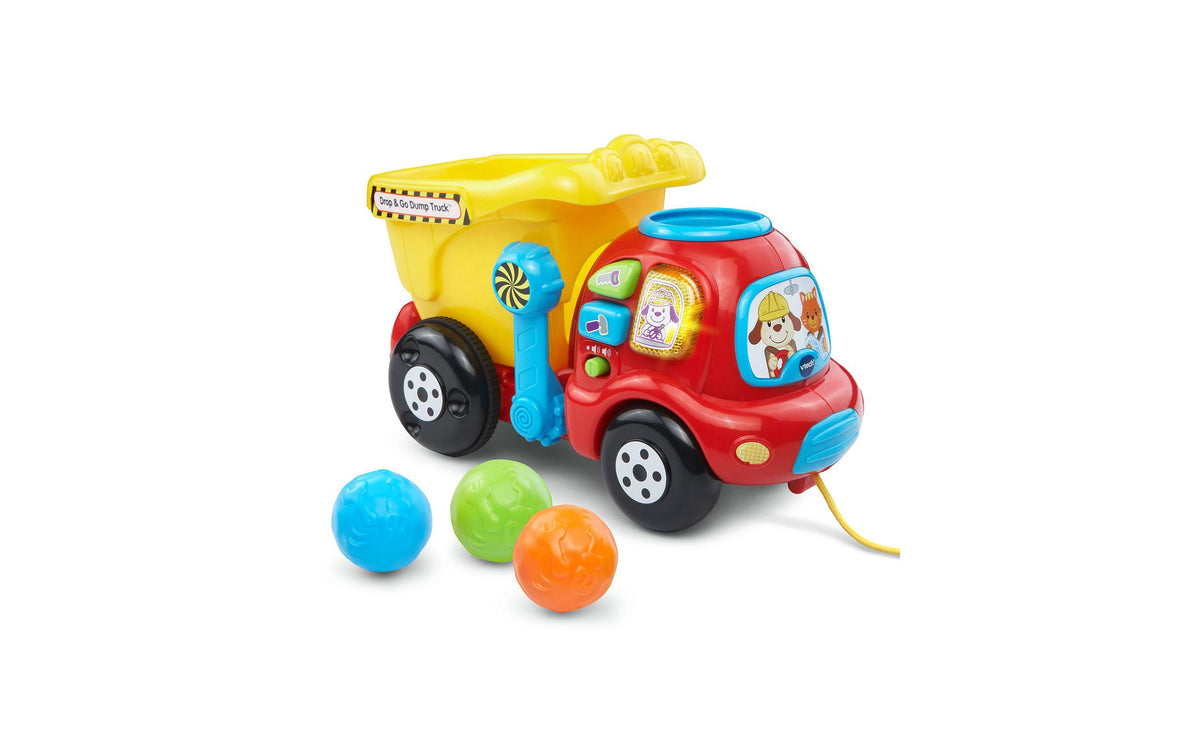 Red and yellow VTech Drop and Go Dump Truck with blue lever and interactive buttons, includes three colorful balls