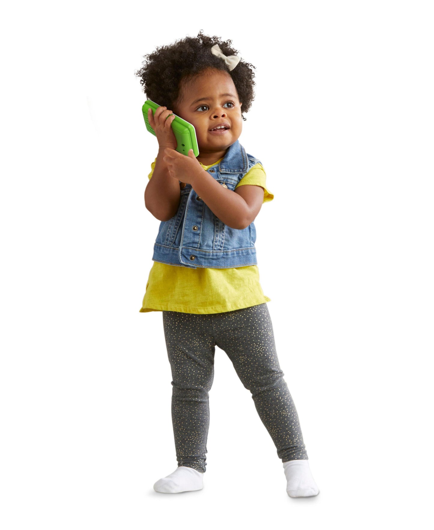 LeapFrog Chat & Count Emoji Phone in bright green held by toddler wearing yellow shirt