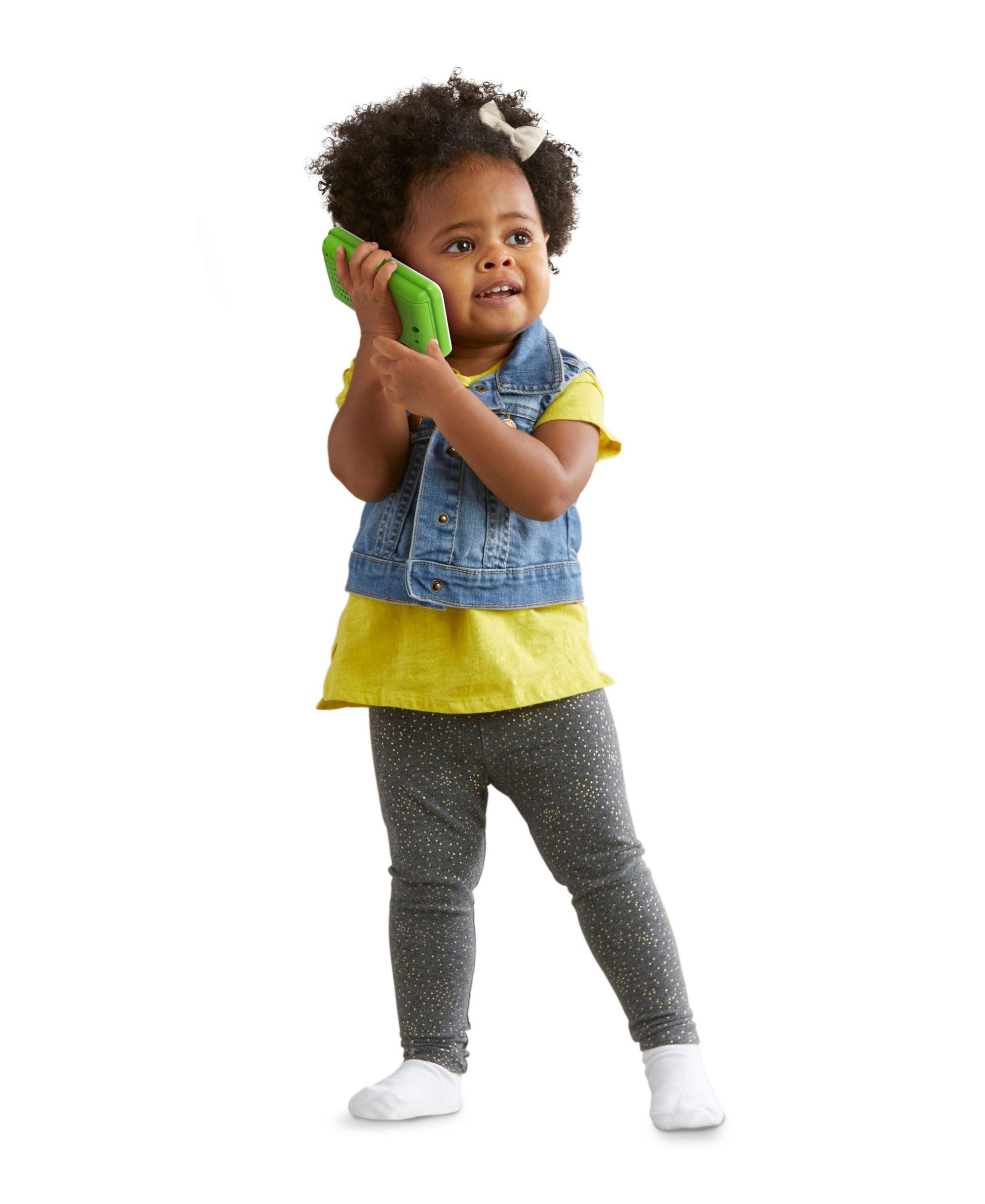 LeapFrog Chat & Count Emoji Phone in bright green held by toddler wearing yellow shirt