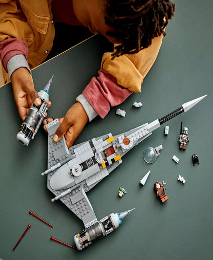 LEGO Star Wars N-1 Starfighter building set with minifigures being assembled by child