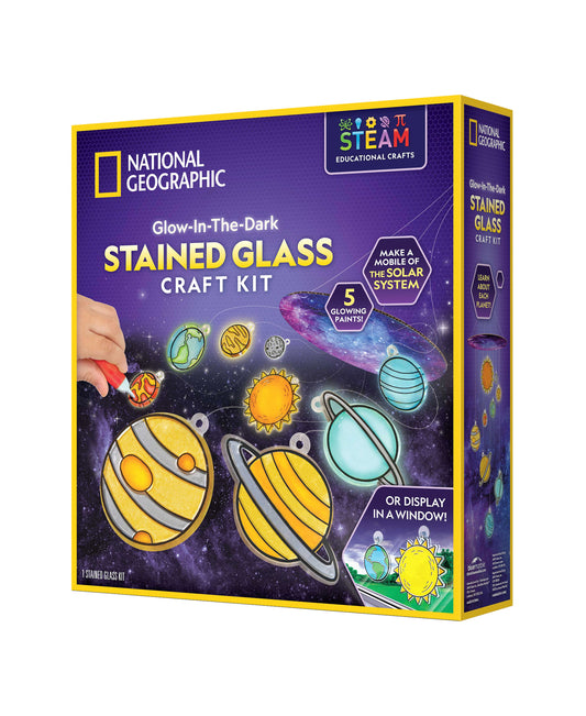 National Geographic Glow-In-The-Dark Stained Glass Craft Kit box showing colorful solar system planets and sun with glowing paints, on purple starry background