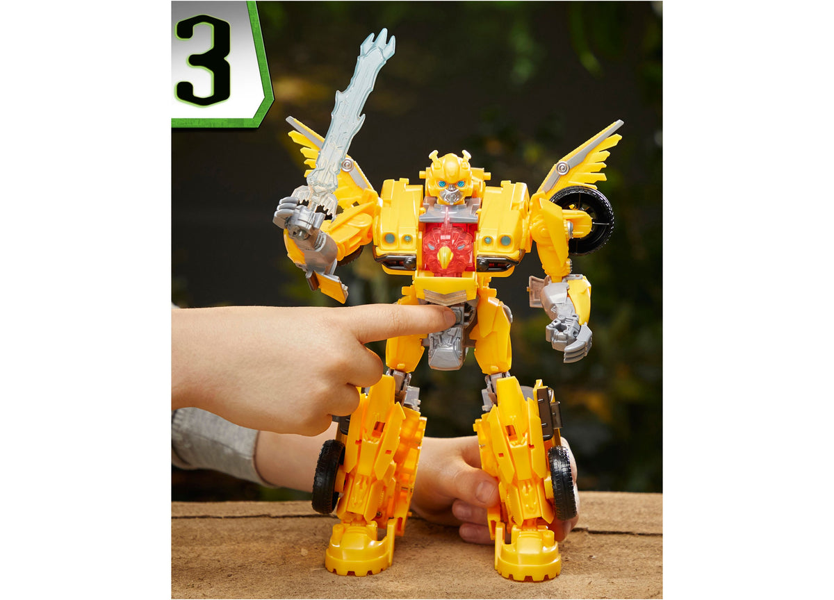 Transformers Bumblebee 10-inch triple changer action figure in yellow and red robot mode with wings, held by child's ...