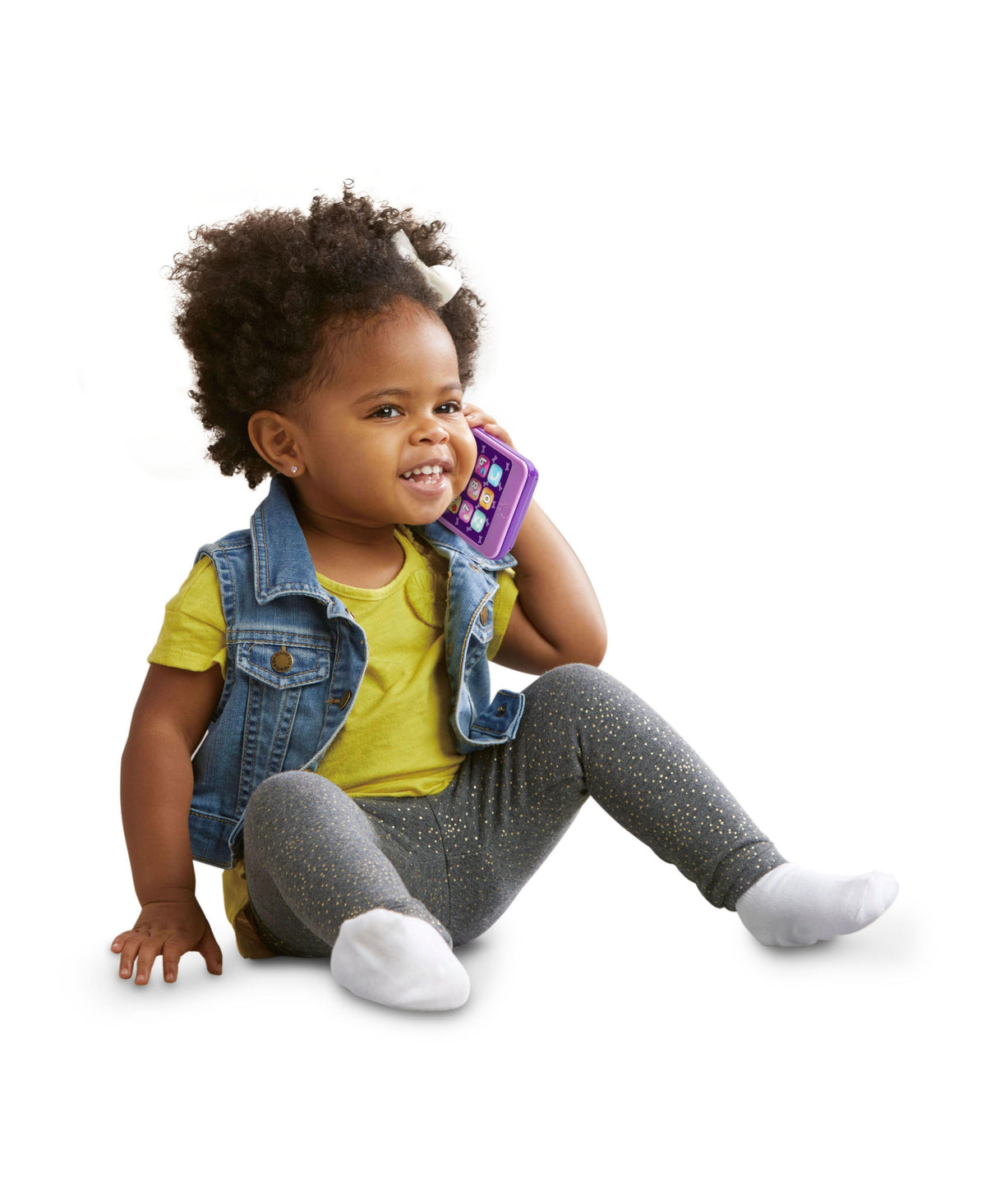 LeapFrog Chat & Count Emoji Phone in purple held by smiling toddler wearing yellow shirt and denim vest