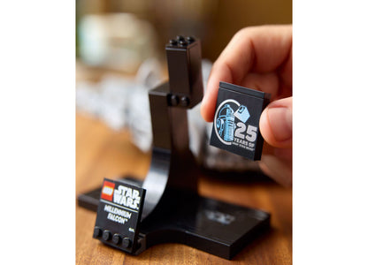 LEGO Star Wars Millennium Falcon 25th Anniversary set with black display stand and commemorative brick