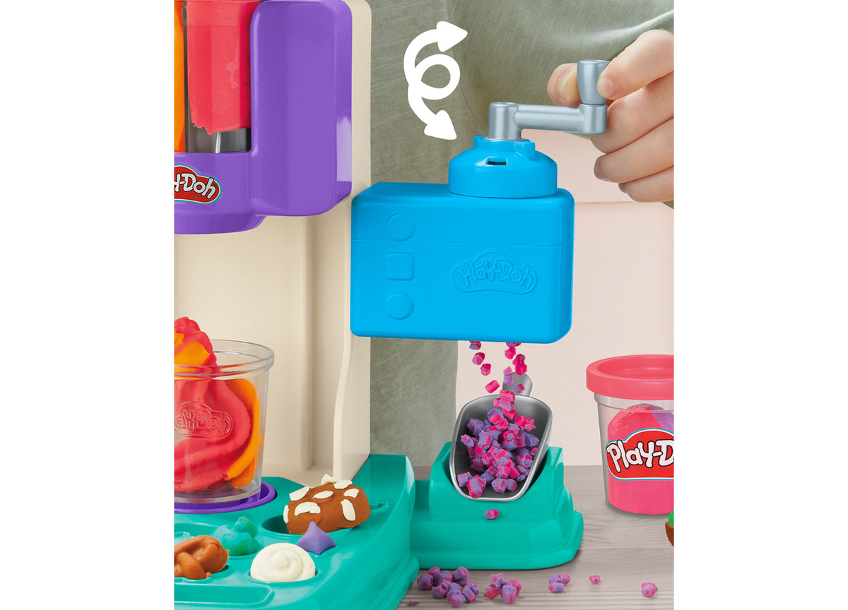Play-Doh Rainbow Swirl Ice Cream Playset with blue ice cream machine, teal base, colorful sprinkles, and accessories