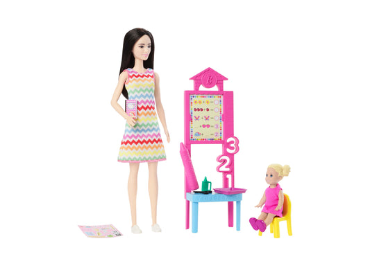 Barbie Teacher doll set with dark-haired teacher doll in rainbow chevron dress, blonde toddler student doll in pink, pink classroom playset with math board and