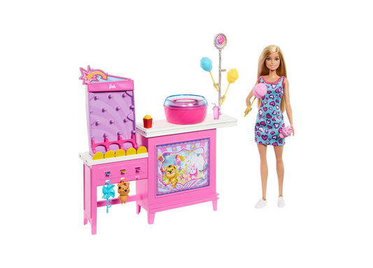 Barbie doll modeled by a child wearing heart-print dress with pink cotton candy game playset featuring arcade-style cabinet, spinning wheel with balloons, and a