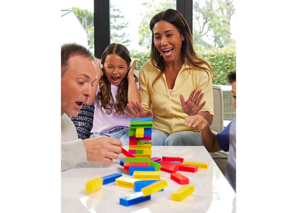UNO Stacko Color & Number Matching Block Game with colorful stacked blocks in red, yellow, blue, and green during fam...