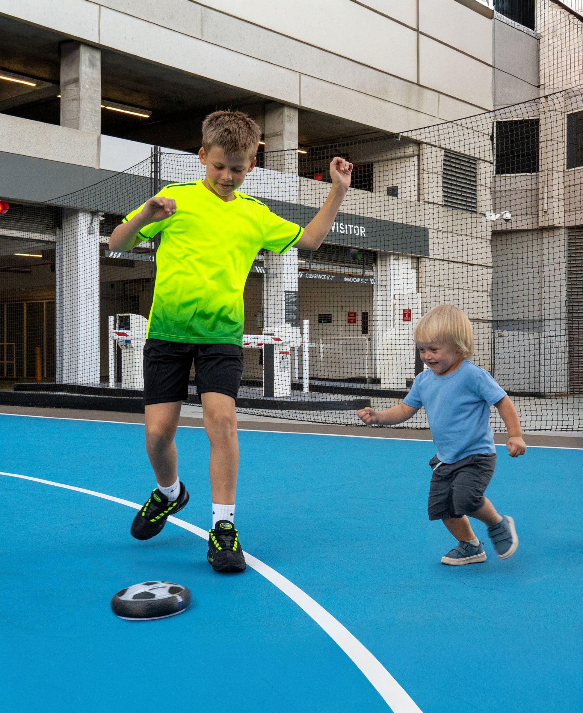 World Tech Toys FIFA Hover Soccer Ball in blue court with children playing