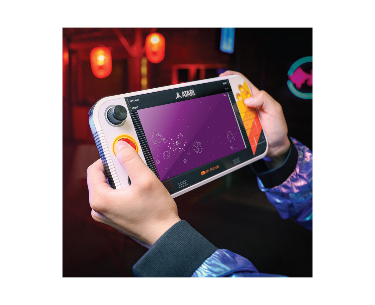 Atari Gamestation Go 7" portable console with purple display showing game interface and yellow control buttons