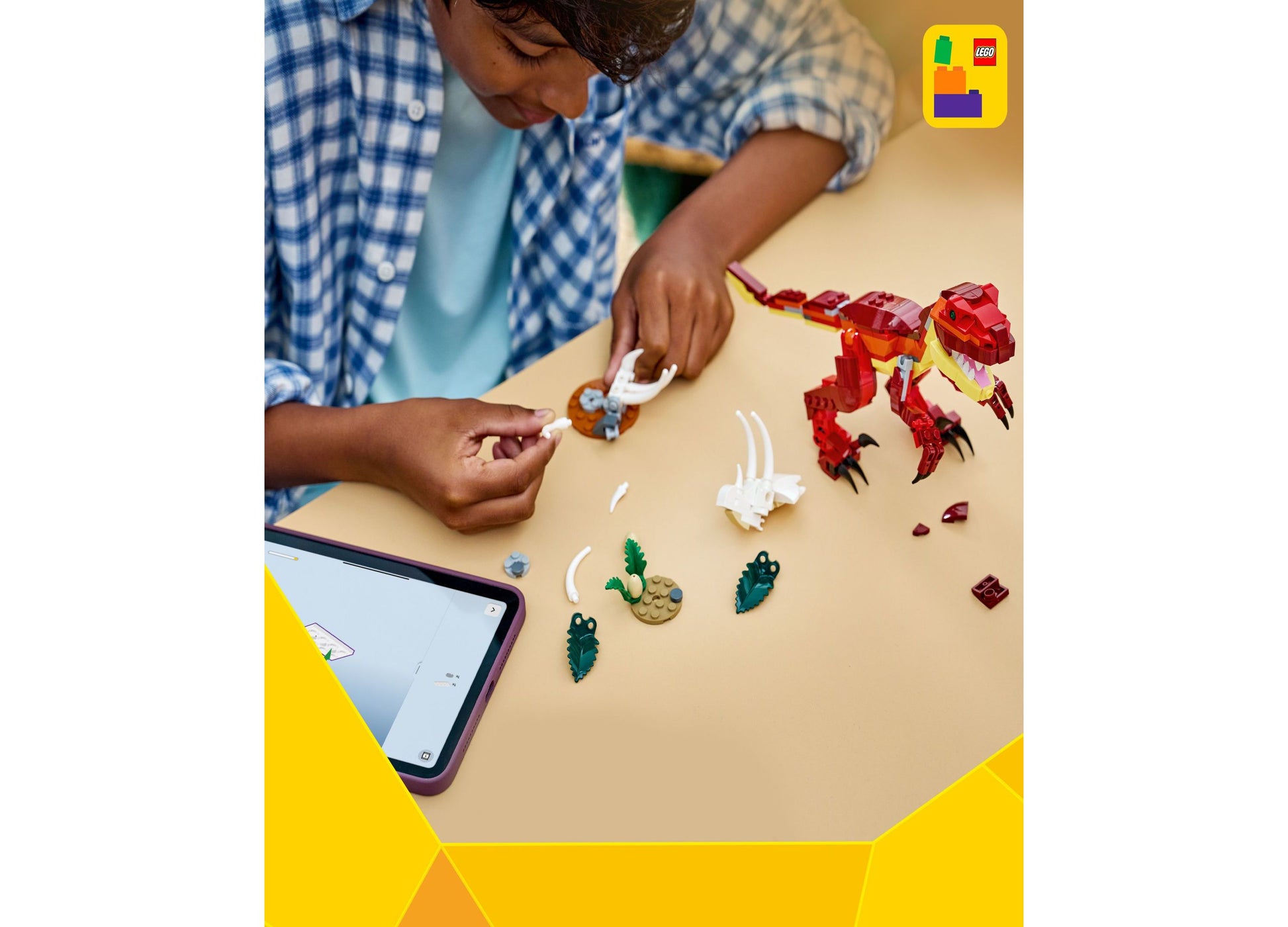 Child building LEGO Creator 3 in 1 Fierce Dinosaur toy with red dinosaur and green cactus pieces