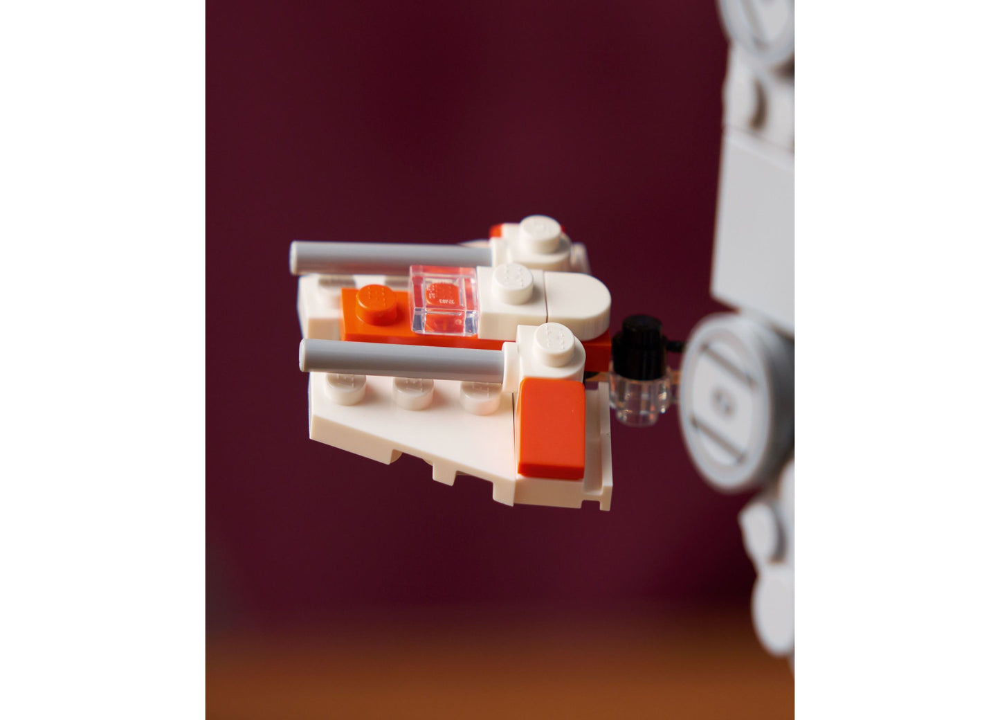 LEGO Star Wars AT-AT Walker Building Set 75440 with cream and orange pieces displayed against maroon background