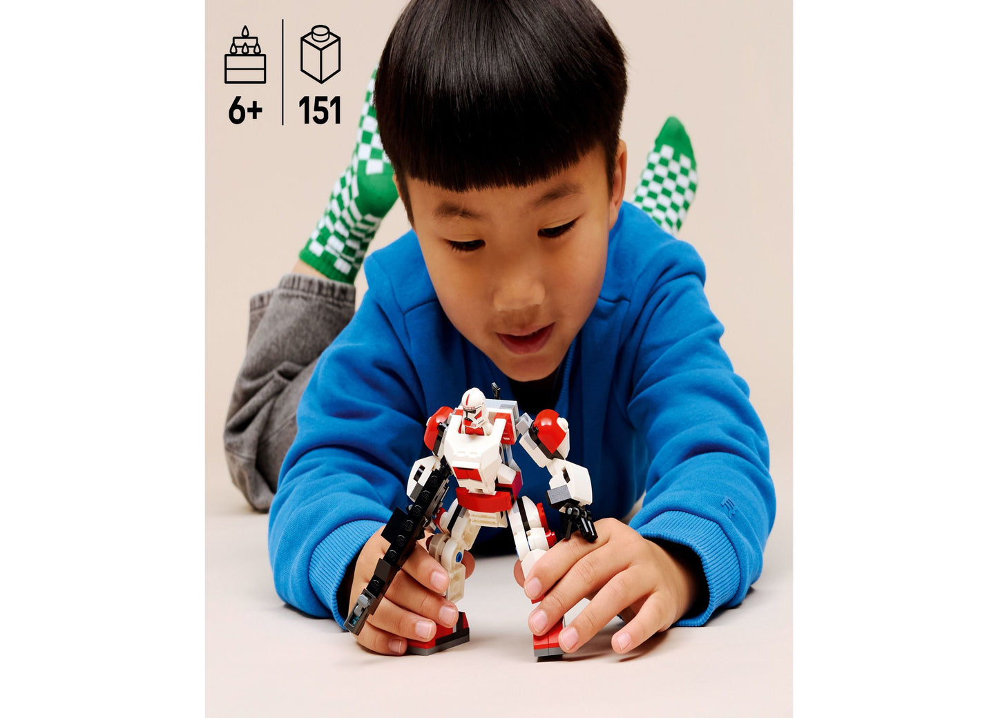 Child playing with LEGO Star Wars Clone Shock Trooper Mech 75448 red and white buildable toy