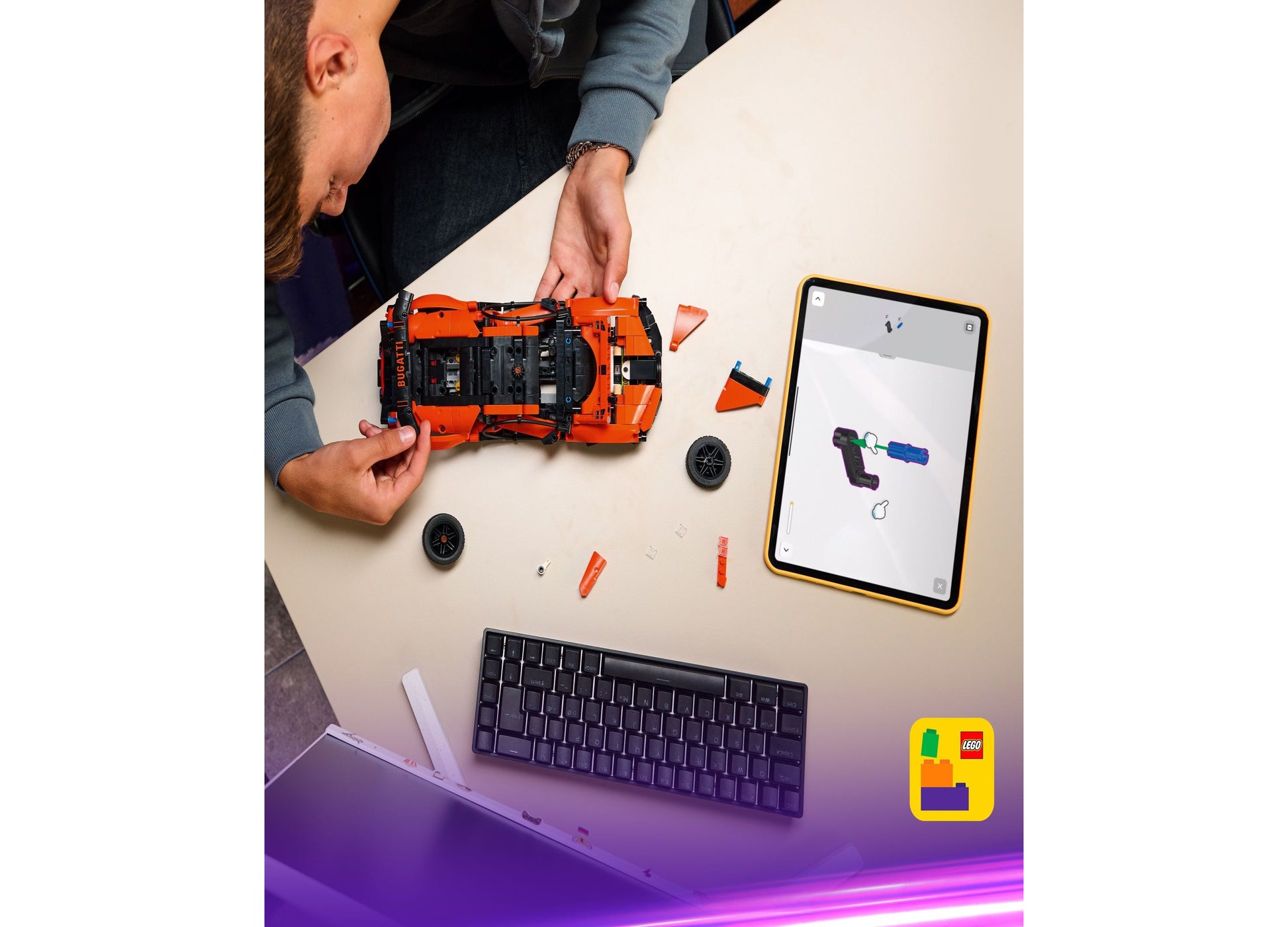 LEGO Technic Bugatti Chiron orange hypercar model with building instructions on tablet