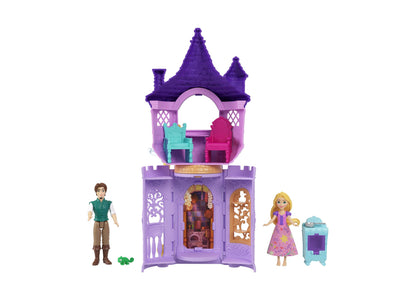 Purple tower playset with two turrets and arched doorway, includes blonde doll in pink dress, male doll in green vest, small turtle figurine, and turquoise robo