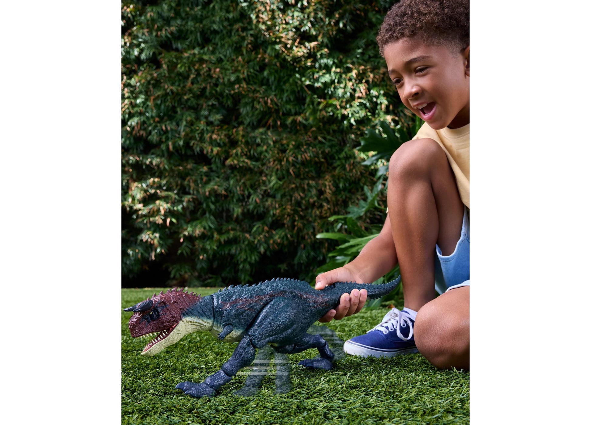 Jurassic World Charge N Chomp Carnotaurus dinosaur toy with roaring action in dark blue and red