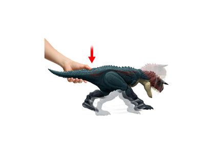 Jurassic World Charge N Chomp Carnotaurus dinosaur toy with dark blue and red coloring, shown being held