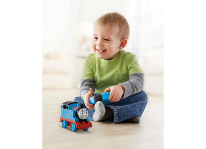 Remote-control Thomas train toy in blue and red being played with by a smiling toddler