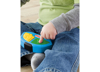 Child's hand pressing green button on blue Fisher Price My First Thomas remote control toy
