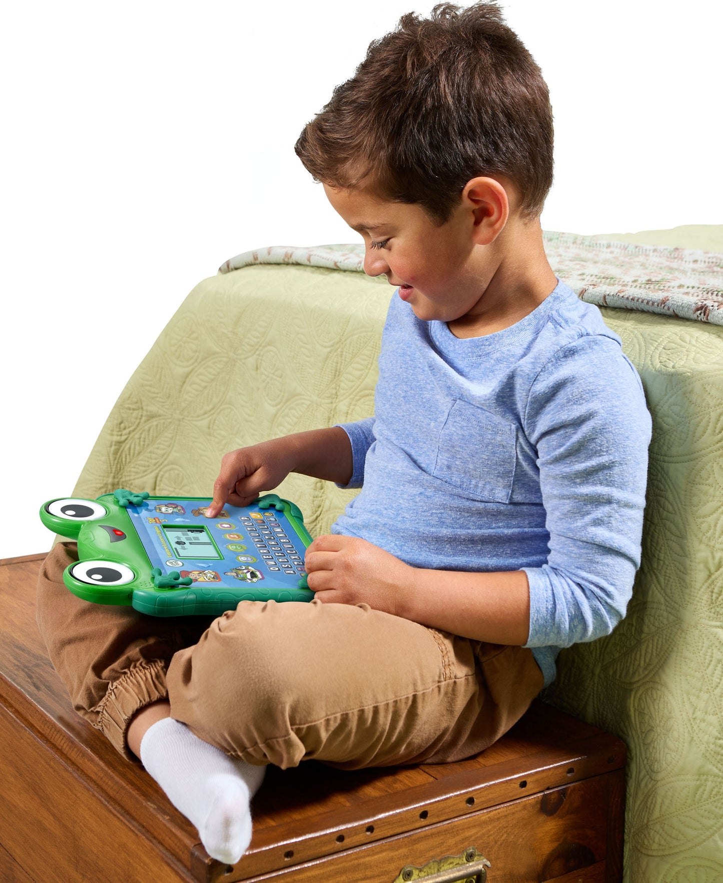 Boy playing with green Leapfrog Toy Story Lilypad Learning Pad on couch