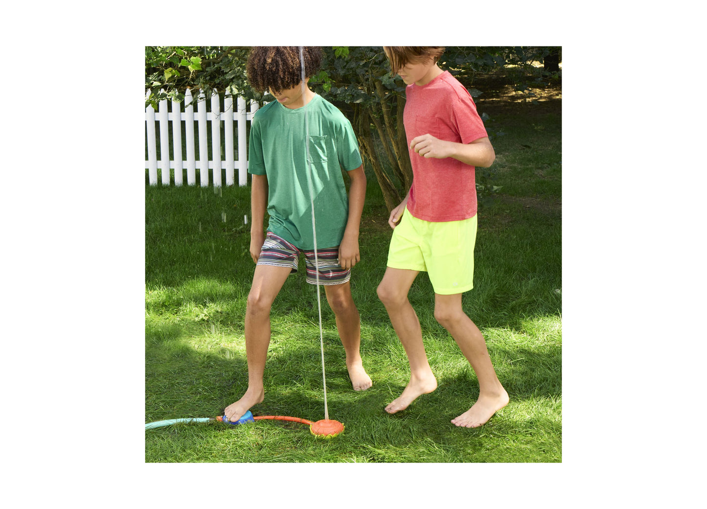 Nerf Super Soaker Stomp and Soak water toy being used by two children on grass