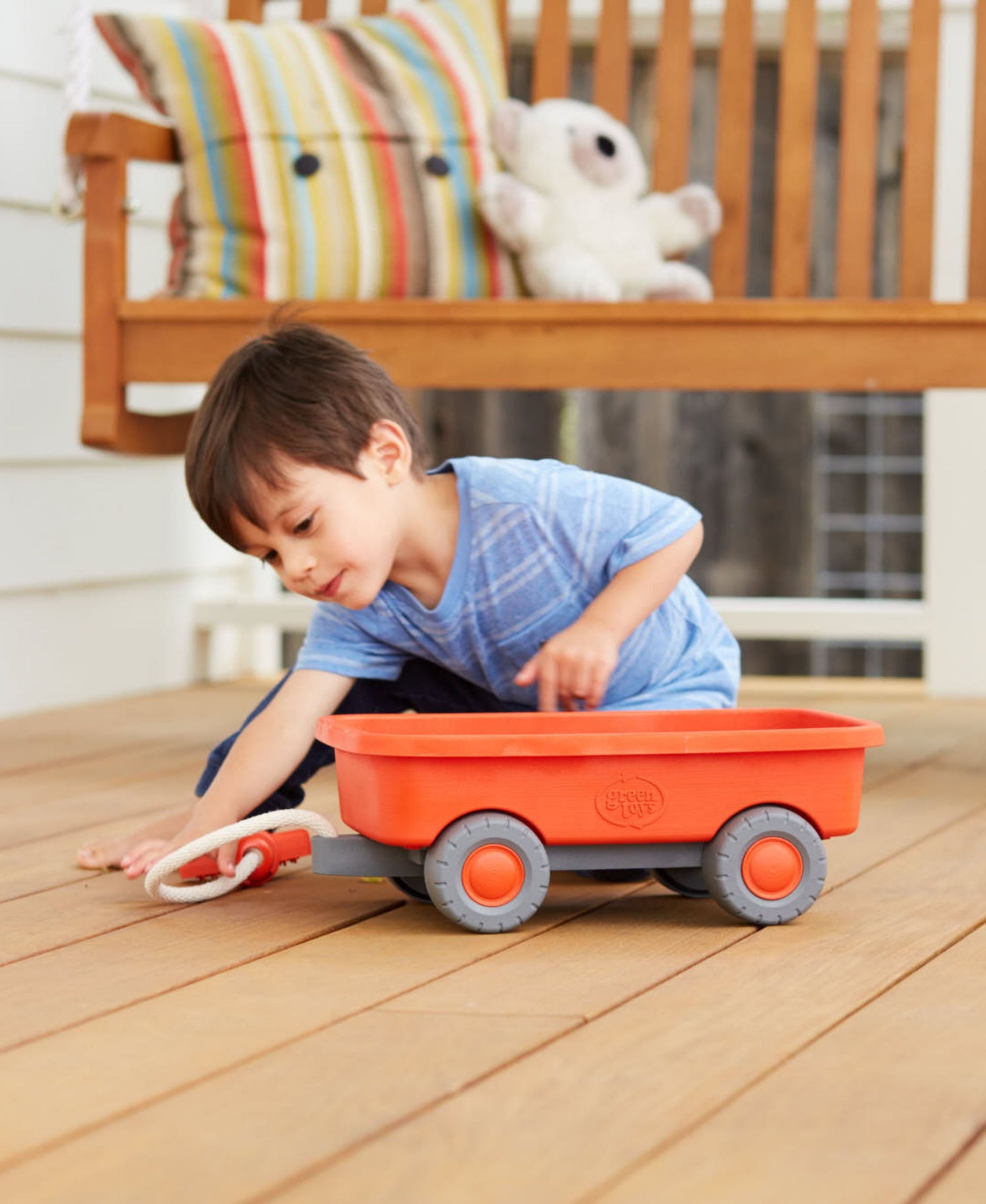 Green Toys Wagon Orange with child playing on wooden floor