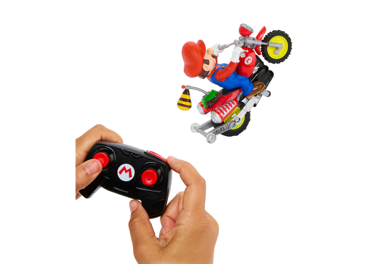 Hot Wheels RC Mario Wheelie Motocross red remote-controlled vehicle with Mario character performing stunt, shown with...