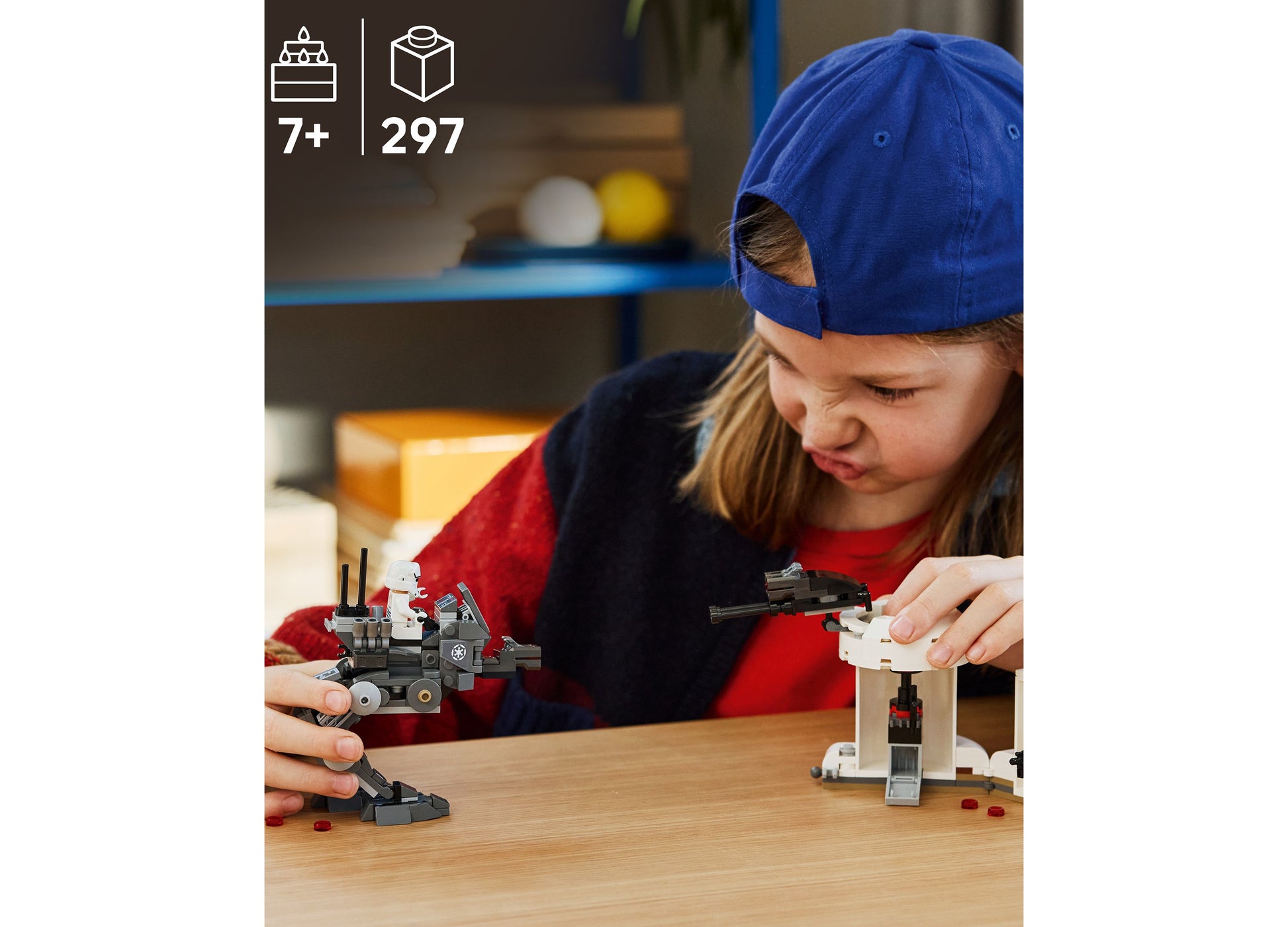 Child building LEGO Star Wars AT-RT Attack 75444 with 297 pieces on wooden table