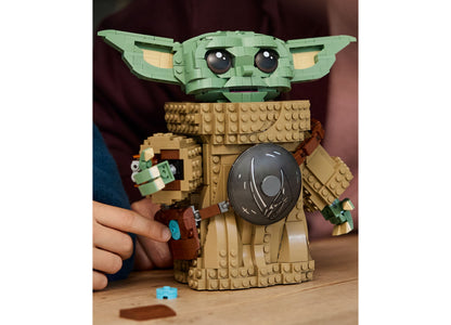 LEGO Star Wars Grogu 75446 building toy with green head, tan robe, and black orb accessory