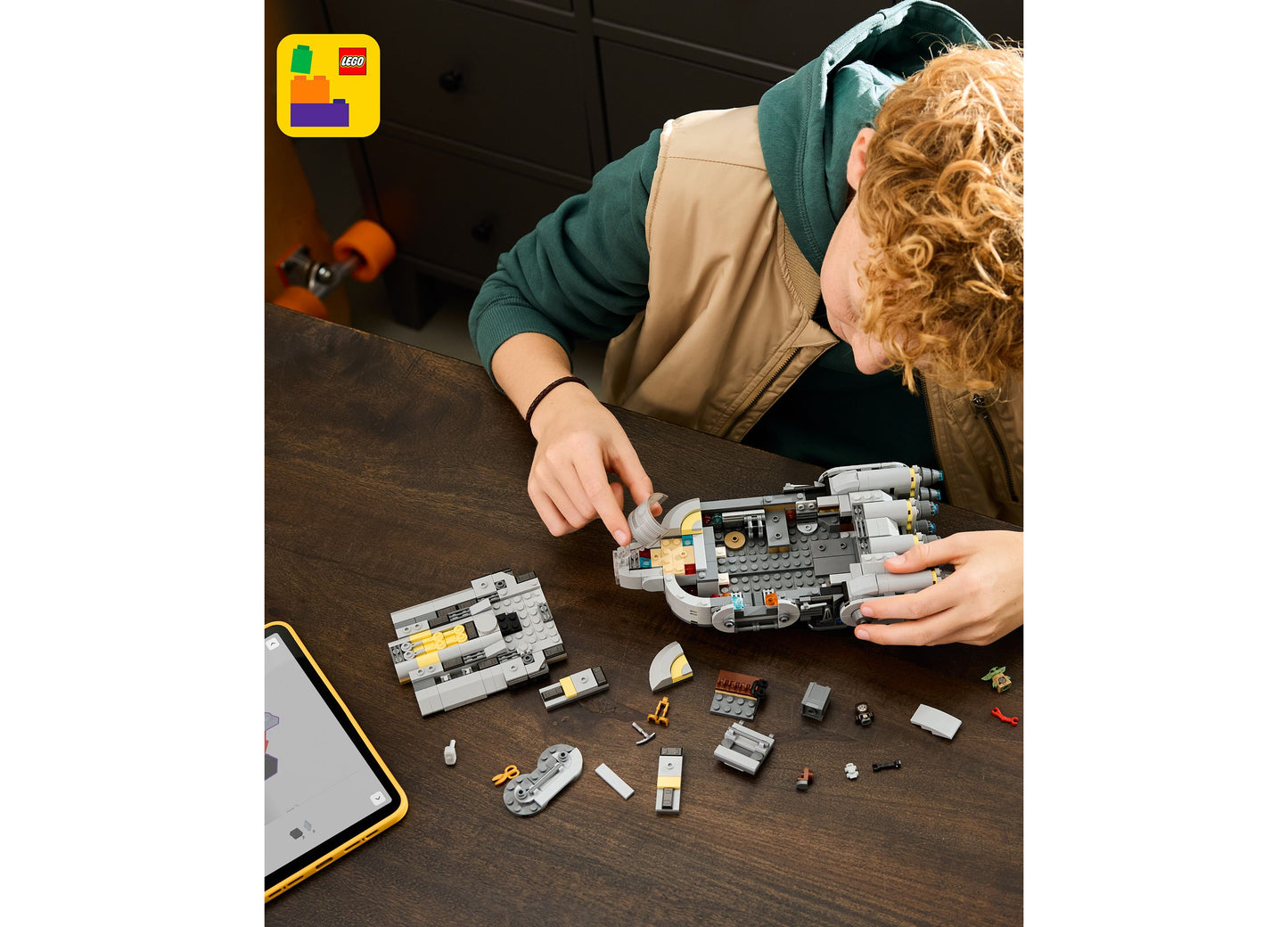 LEGO Star Wars Mandalorian Starship 75445 building set with 701 pieces being assembled by child
