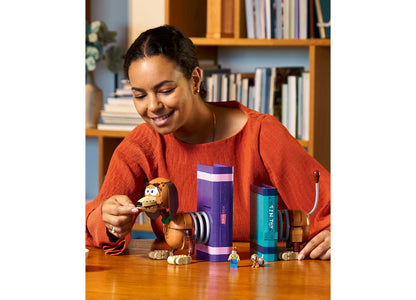 Girl playing with LEGO Disney Toy Story Slinky Dog Bookends set with purple and teal containers