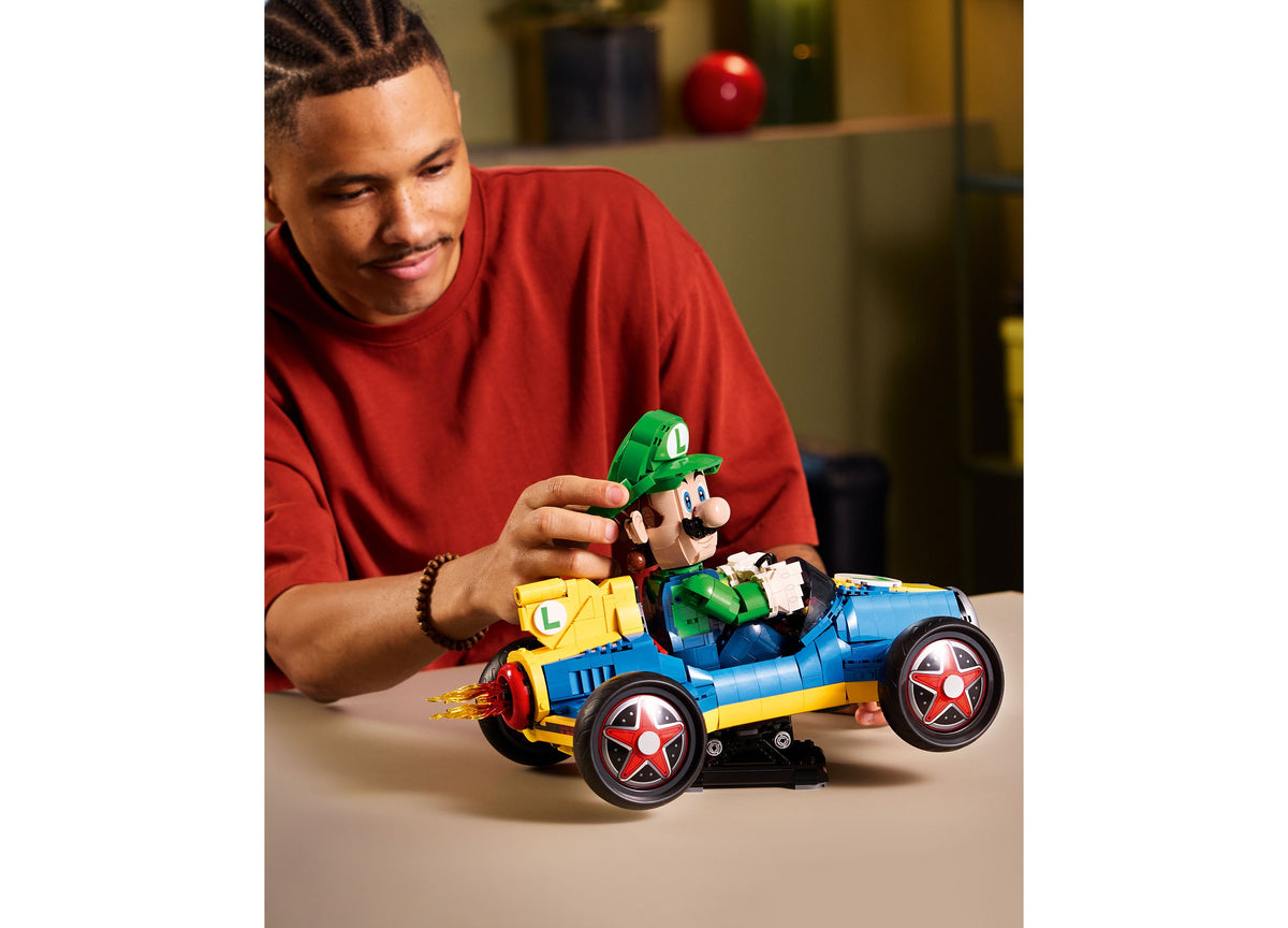 LEGO Mario Kart Luigi Mach 8 blue and yellow race car set with minifigure being played with