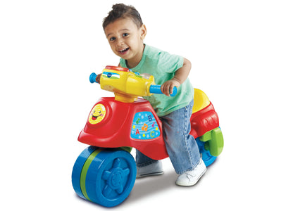 VTech 2-in-1 Learn & Zoom Motorbike in red, yellow, and blue with toddler riding